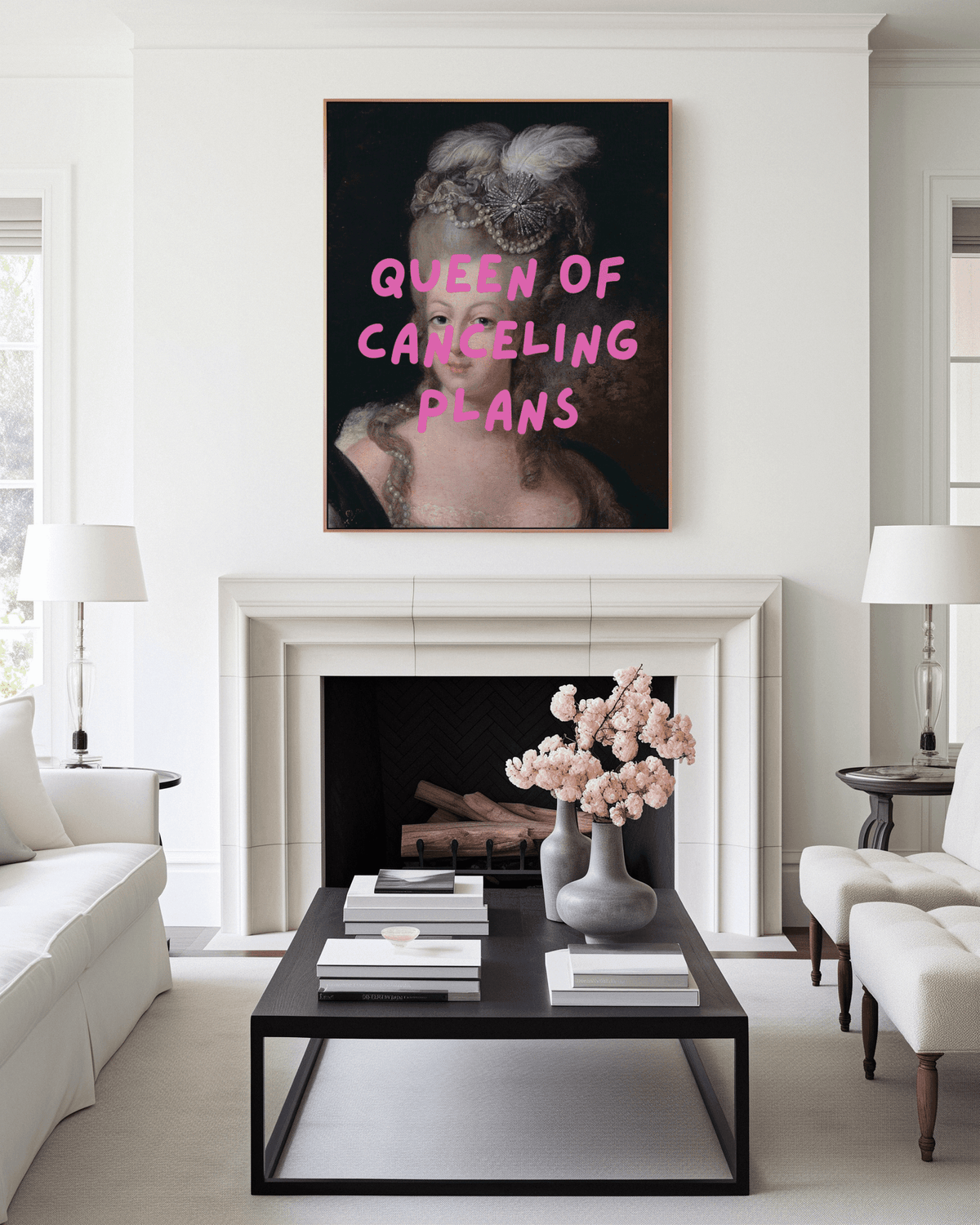 Queen of Canceling Plans print above a white fireplace in a bright living room with a black coffee table