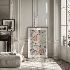 Red and blue floral wall art in a black frame in a Parisian-style room with a fireplace and tall windows