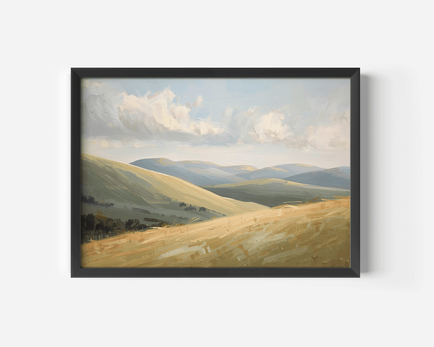 A black-framed nature landscape wall art print of rolling green and golden hills under a cloudy sky.