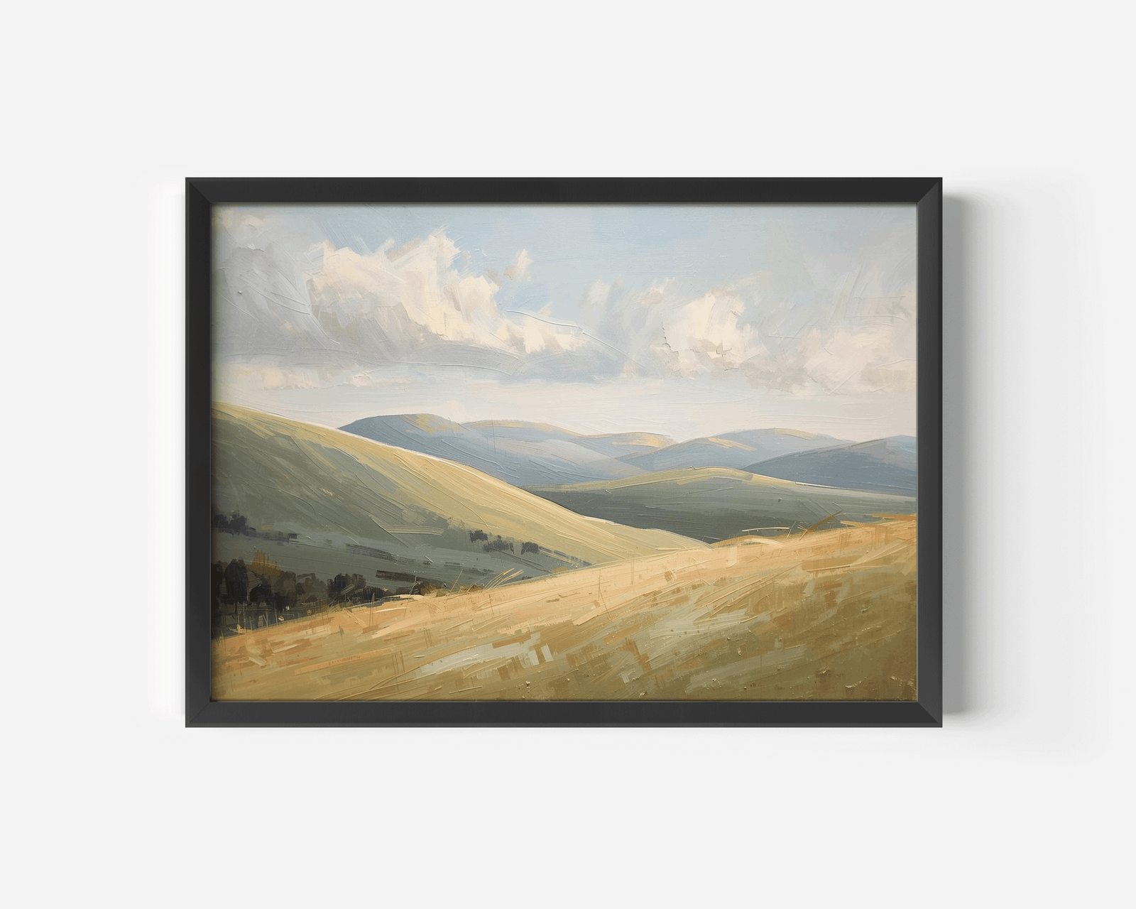 A black-framed nature landscape wall art print of rolling green and golden hills under a cloudy sky.
