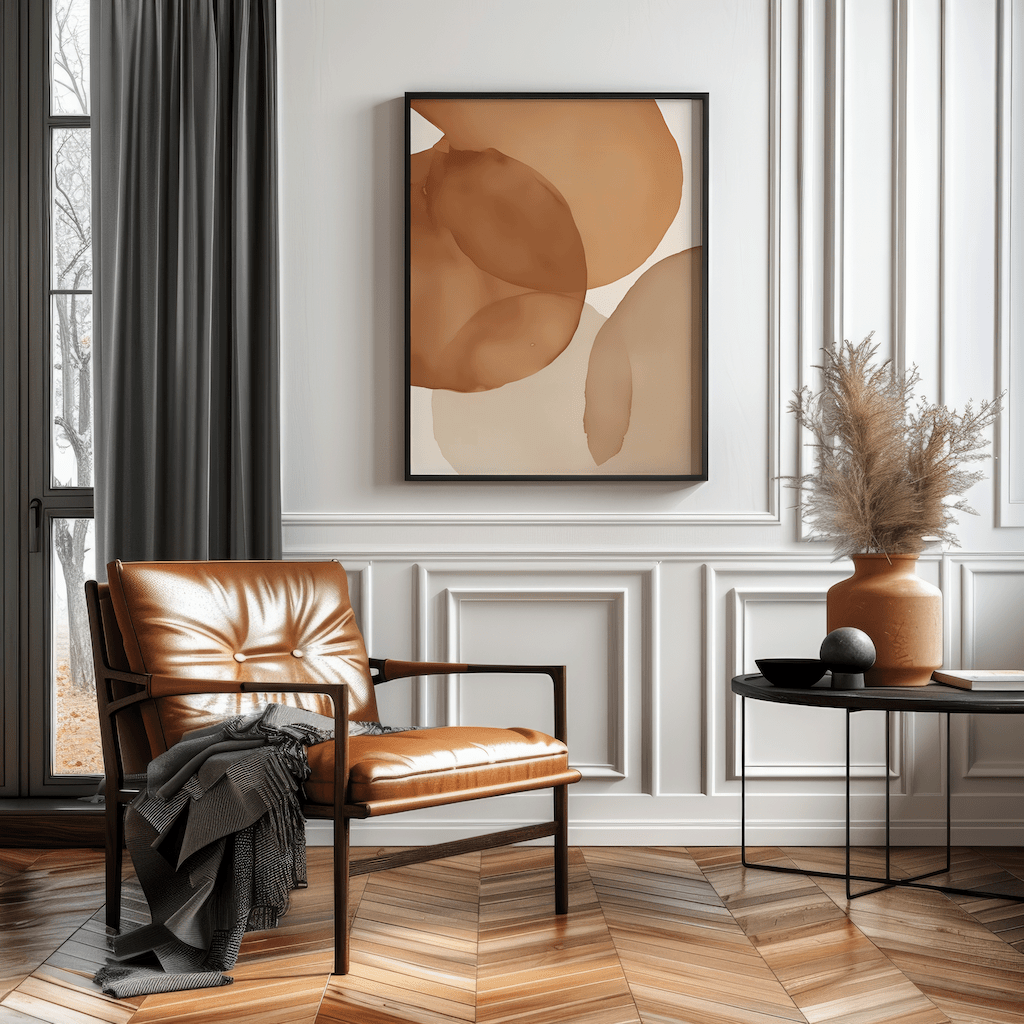 Rust brown terracotta abstract wall art framed print styled in modern living room with leather chair. A mix of beige, cream, grey, burnt orange and brown with a watercolor effect.