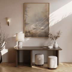 Wooden console table in entryway with a wood-framed vintage rustic abstract canvas print of swans on a lake.