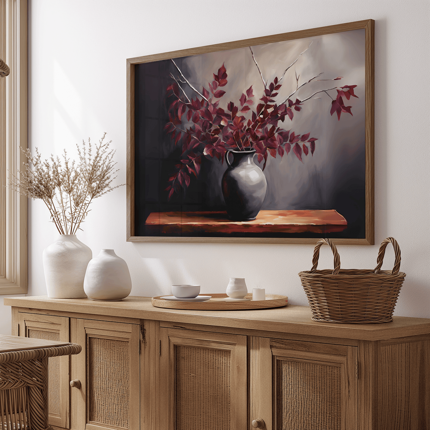 Framed rustic, vintage botanical wall art with burgundy leaves in dark grey vase in a dining room above a wooden sideboard console