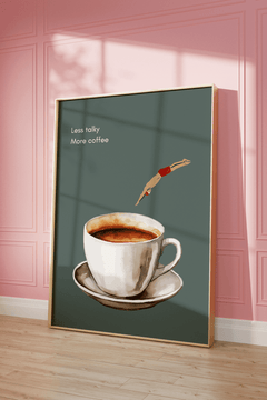 Sage green coffee wall art in a natural wood frame leaning against a pink panelled wall