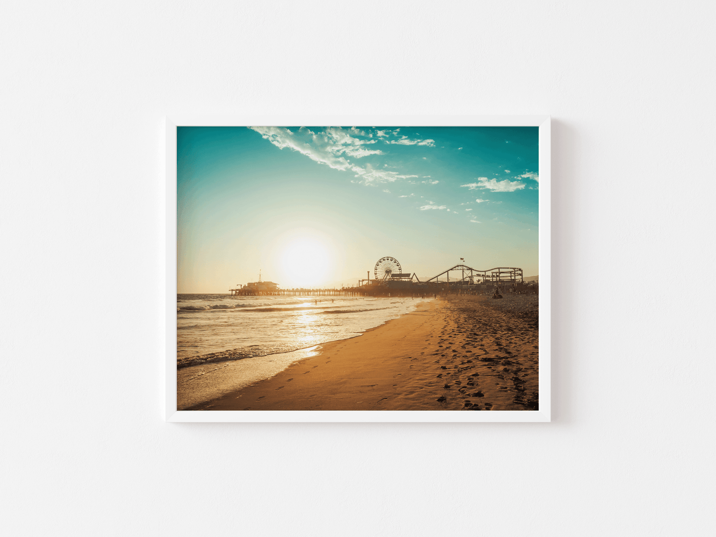White framed Santa Monica wall art of the pier at sunset on plain background