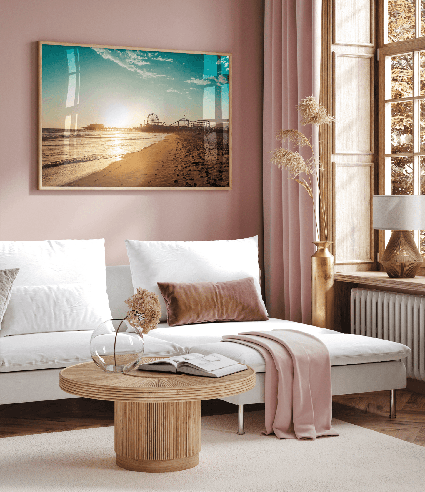 Natural framed Santa Monica wall art above a white sofa in a pink-toned living room