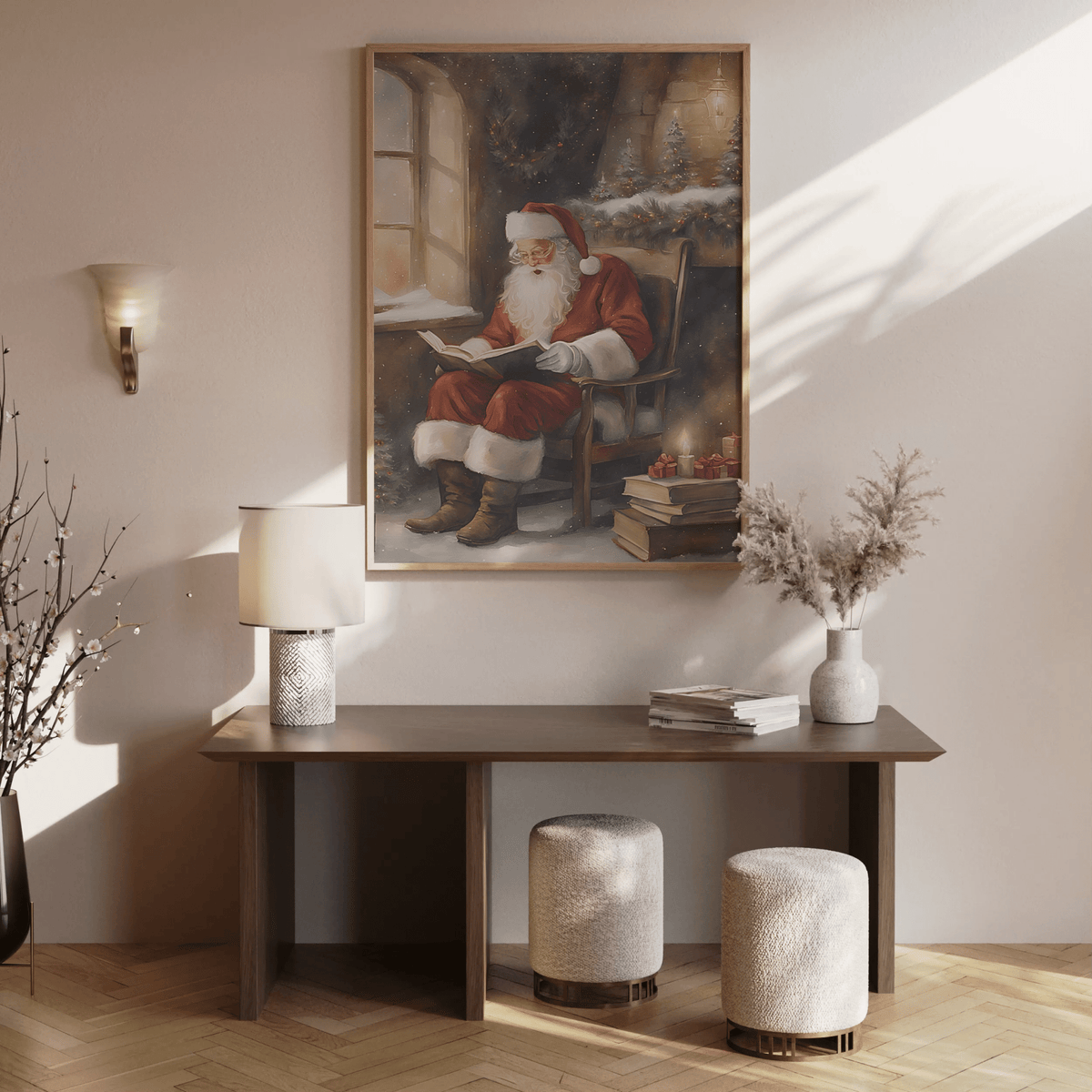 large Christmas canvas print of Santa reading by the fire hanging in cozy entryway or hallway with flocked tree above a wooden console table with boho vases and flowers.