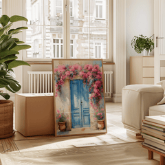 Natural framed Santorini blue door wall art leaning in a bright living room with a plant