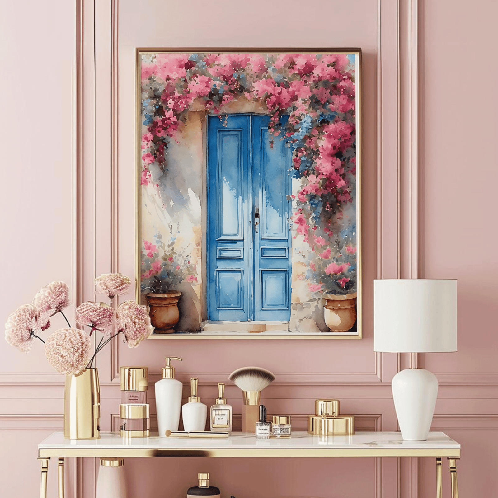 Gold framed Santorini blue door wall art above a pink vanity table