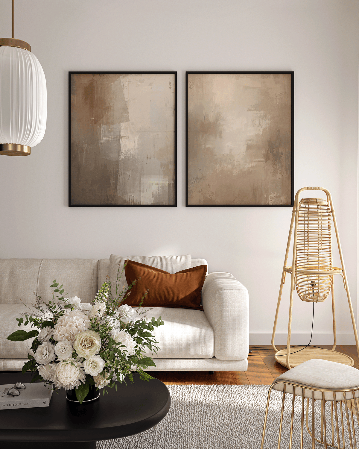 large set of two warm beige and brown abstract canvas wall art prints framed above a cream sofa in a contemporary living room
