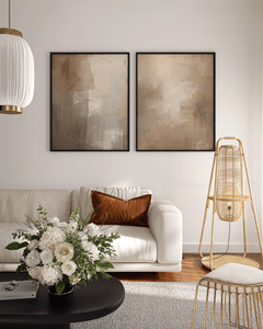 large set of two warm beige and brown abstract canvas wall art prints framed above a cream sofa in a contemporary living room