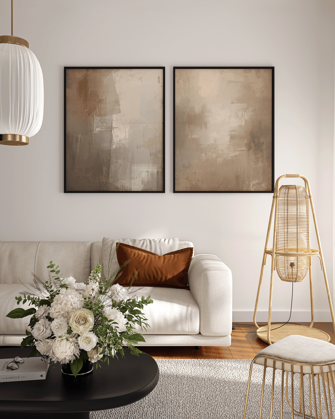 large set of two warm beige and brown abstract canvas wall art prints framed above a cream sofa in a contemporary living room