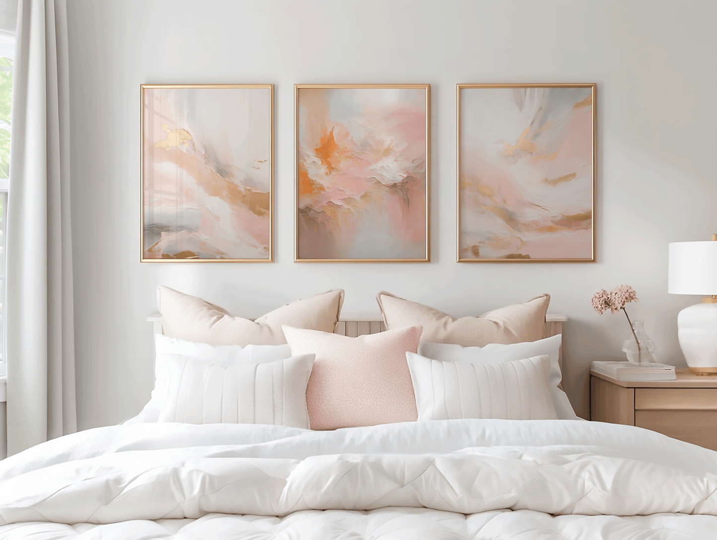 Set of three blush pink and gold abstract wall art prints styled above bed with neutral decor
