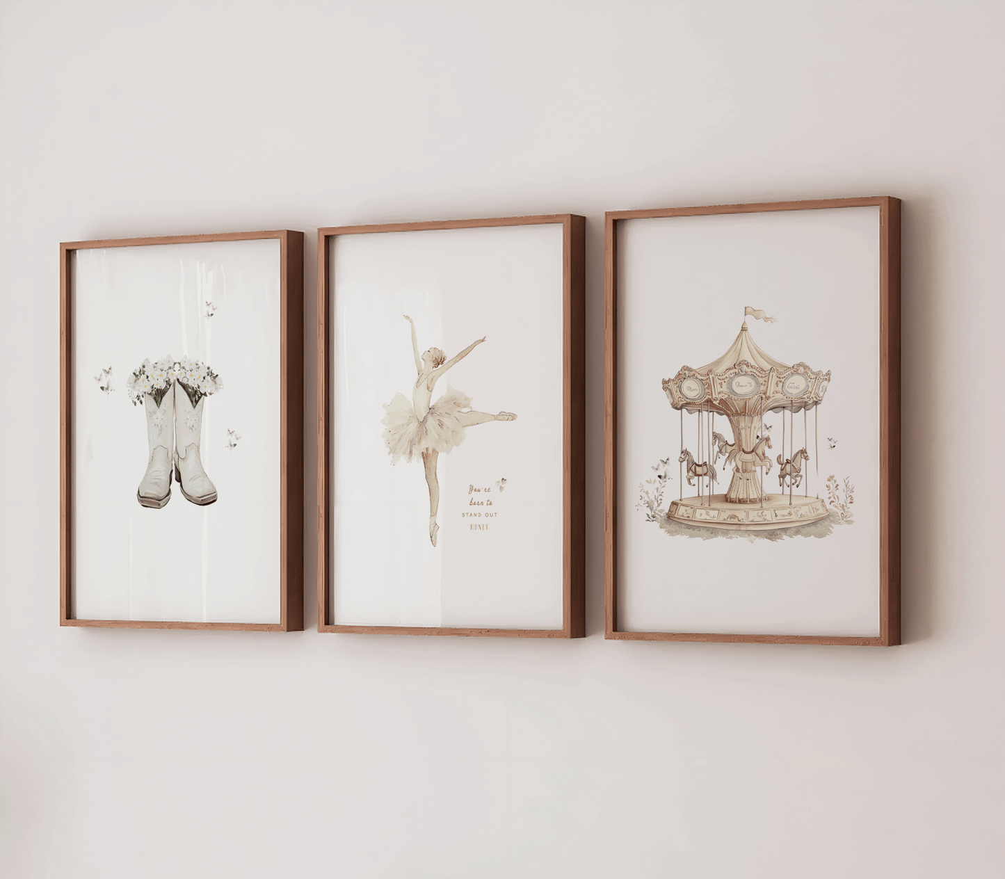 Set of 3 vintage nursery wall art prints framed on a white wall featuring a vintage carousel print in a wooden frame, a vintage ballerina in a tutu, and boots with flowers and butterflies