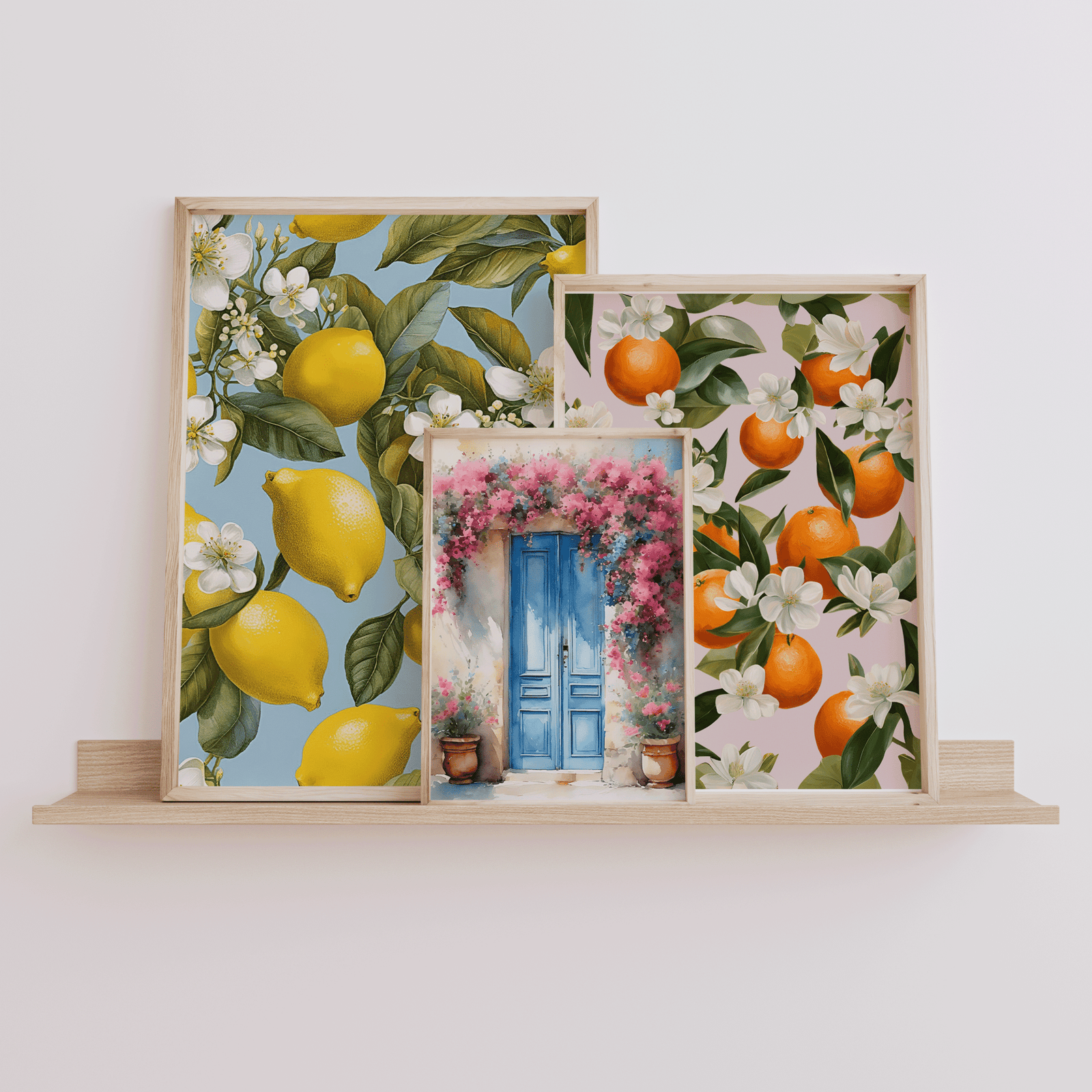 Mediterranean citrus and lemon prints, and Santorini blue doors with pink flowers, displayed on a wooden shelf with natural light — kitchen or dining art décor