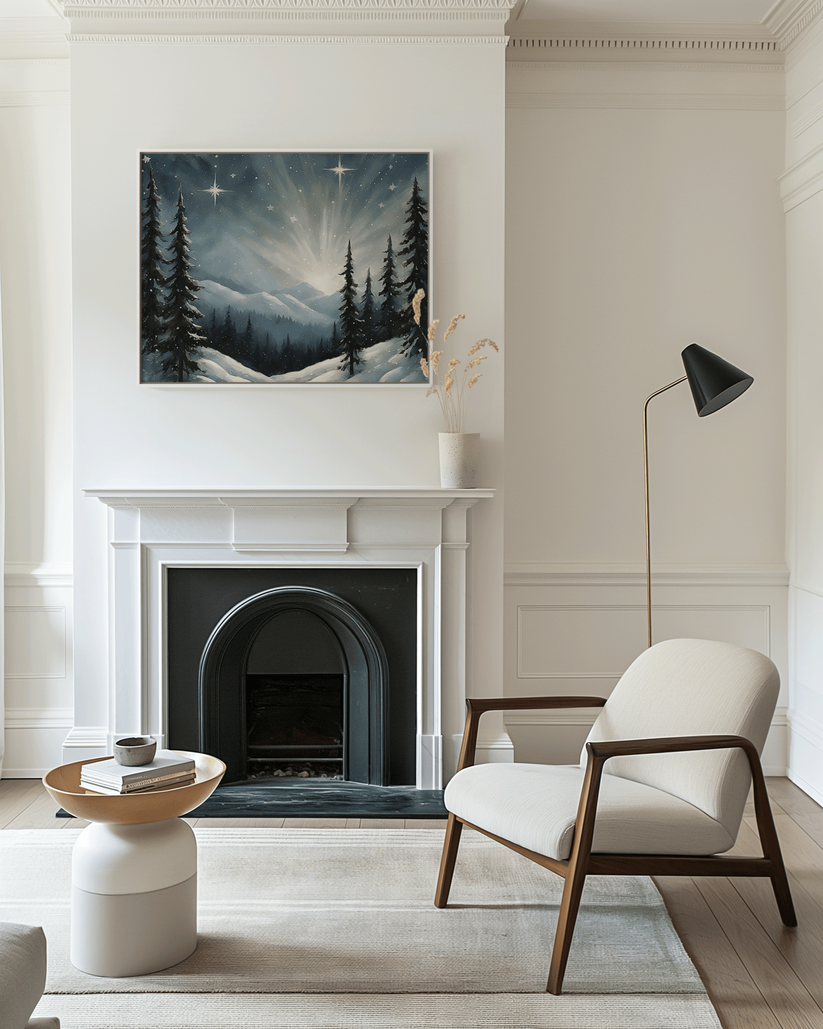 Framed starry winter night Christmas wall art with snowy mountain scene and glowing stars, displayed above a white fireplace in a neutral modern living room with soft natural light.