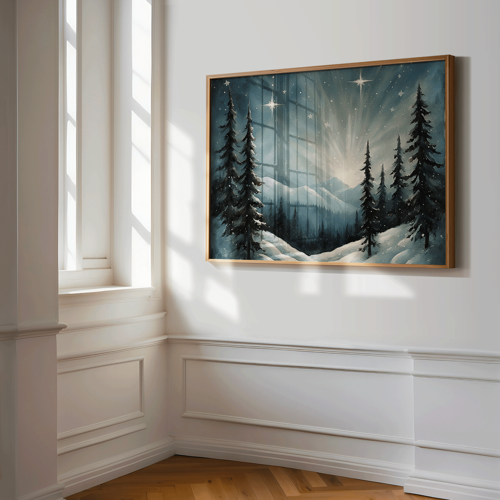 Framed starry winter night Christmas wall art with snowy pine trees and glowing starlight, displayed in a bright neutral hallway with white walls and natural light.