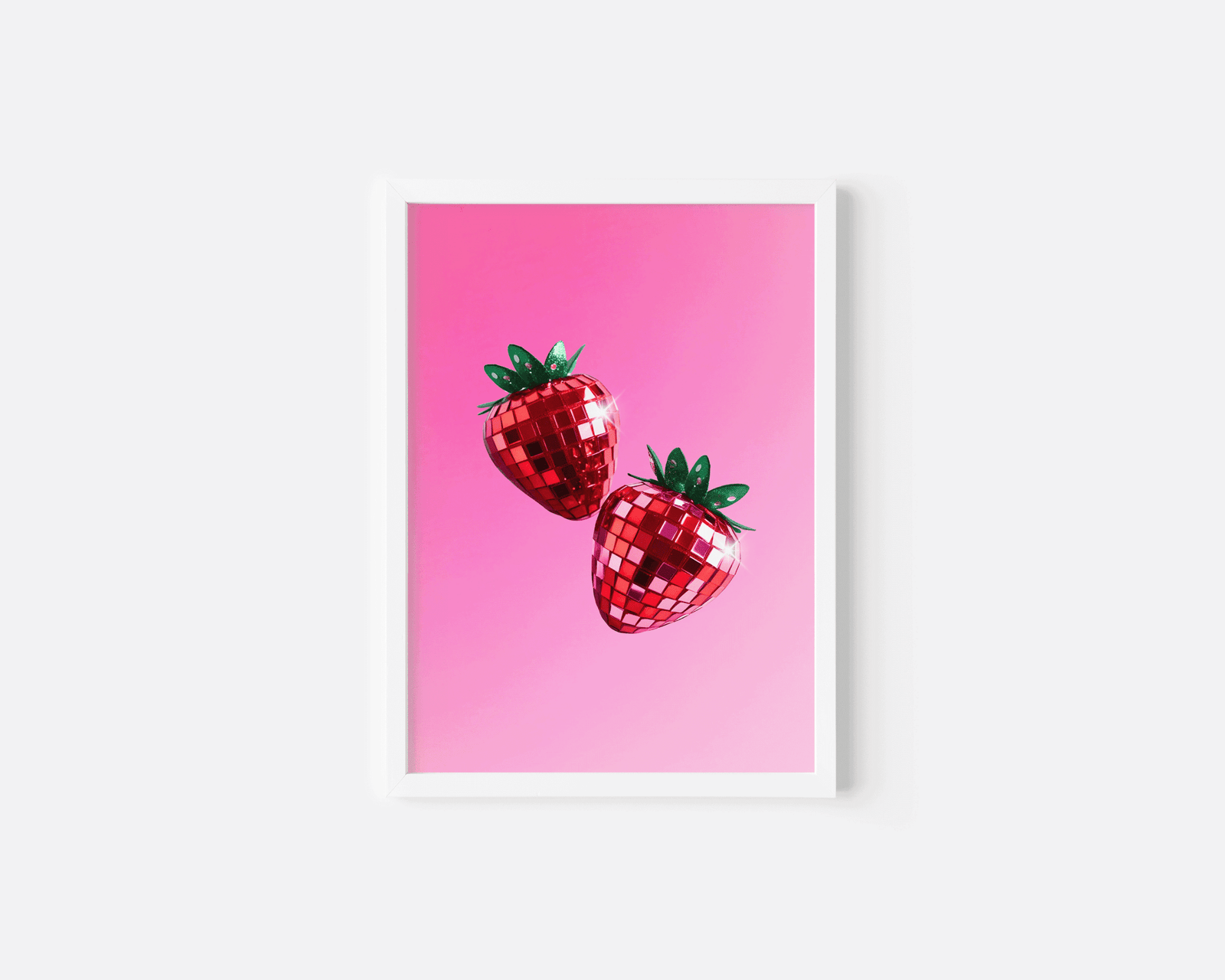 Strawberry disco ball print in a small white frame on a white background