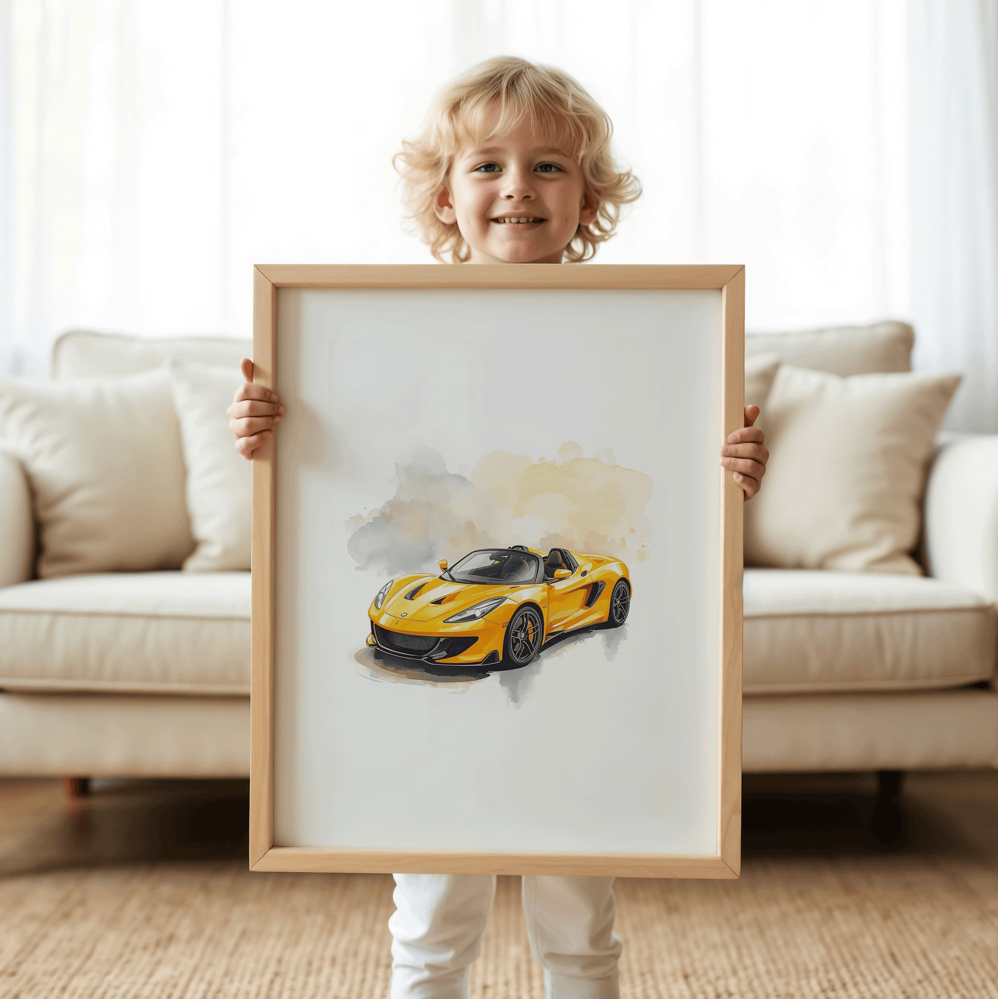 Toddler boy smiling while holding a large framed yellow watercolor sports car print, featuring soft abstract splashes, glossy car detailing, and playful styling similar to hot wheels car wall art for car-loving kids.