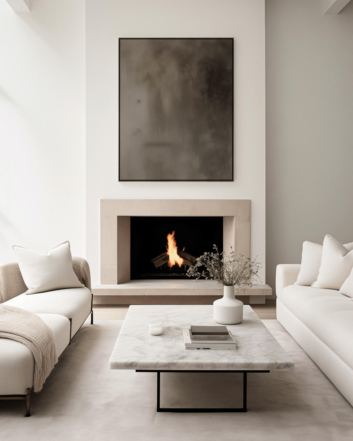 Moody earthy tonal abstract wall art framed above modern fireplace in neutral living room with cream couches and marble table