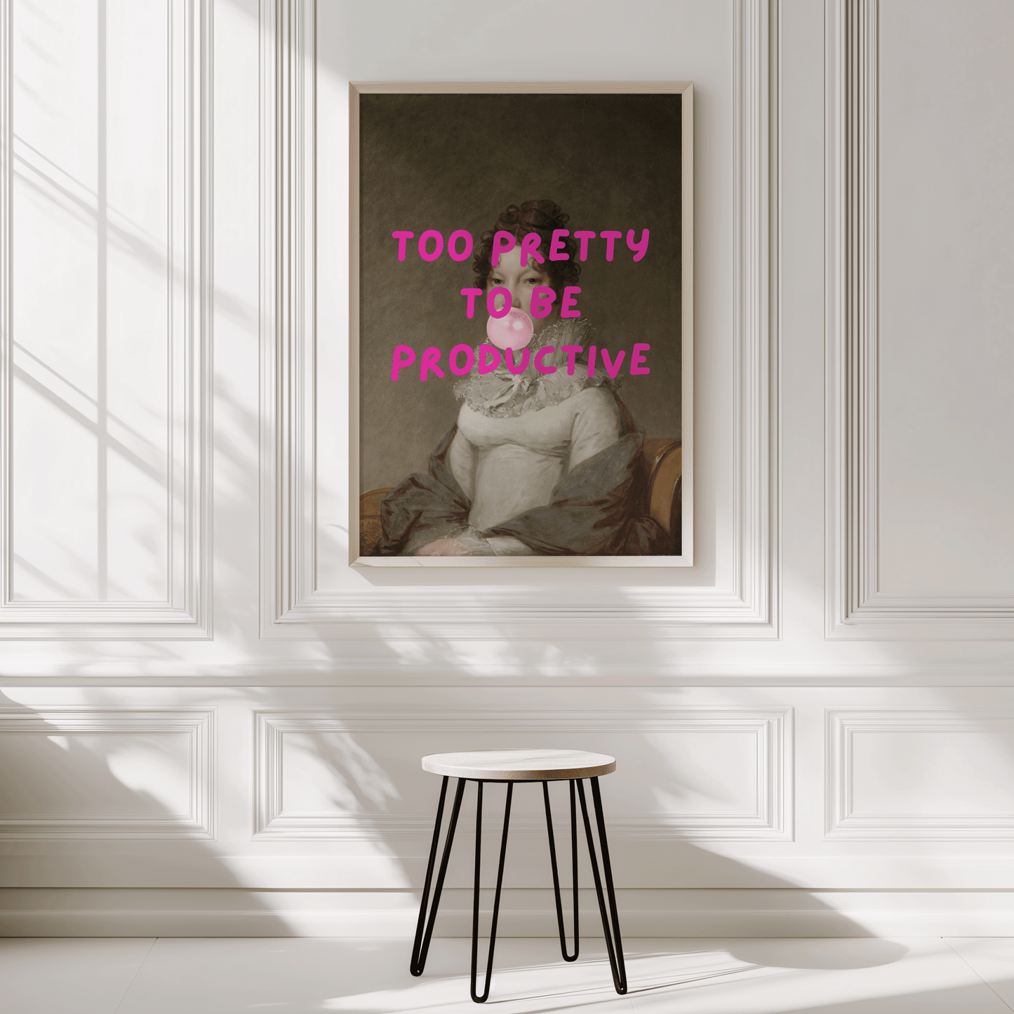 Framed funny retro wall art print with text 'Too Pretty to be Productive' on a wall with a stool.