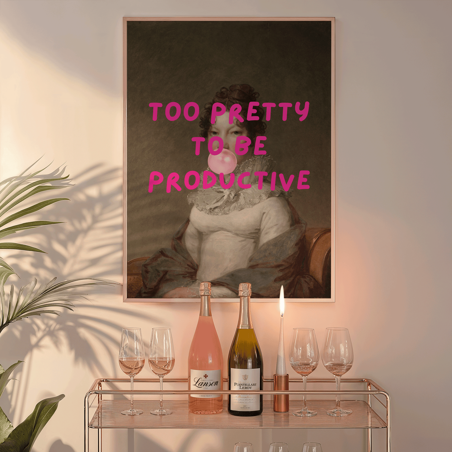 Framed canvas wall art print with text 'Too Pretty to be Productive' in pink text above a bar cart with champagne and glasses.
