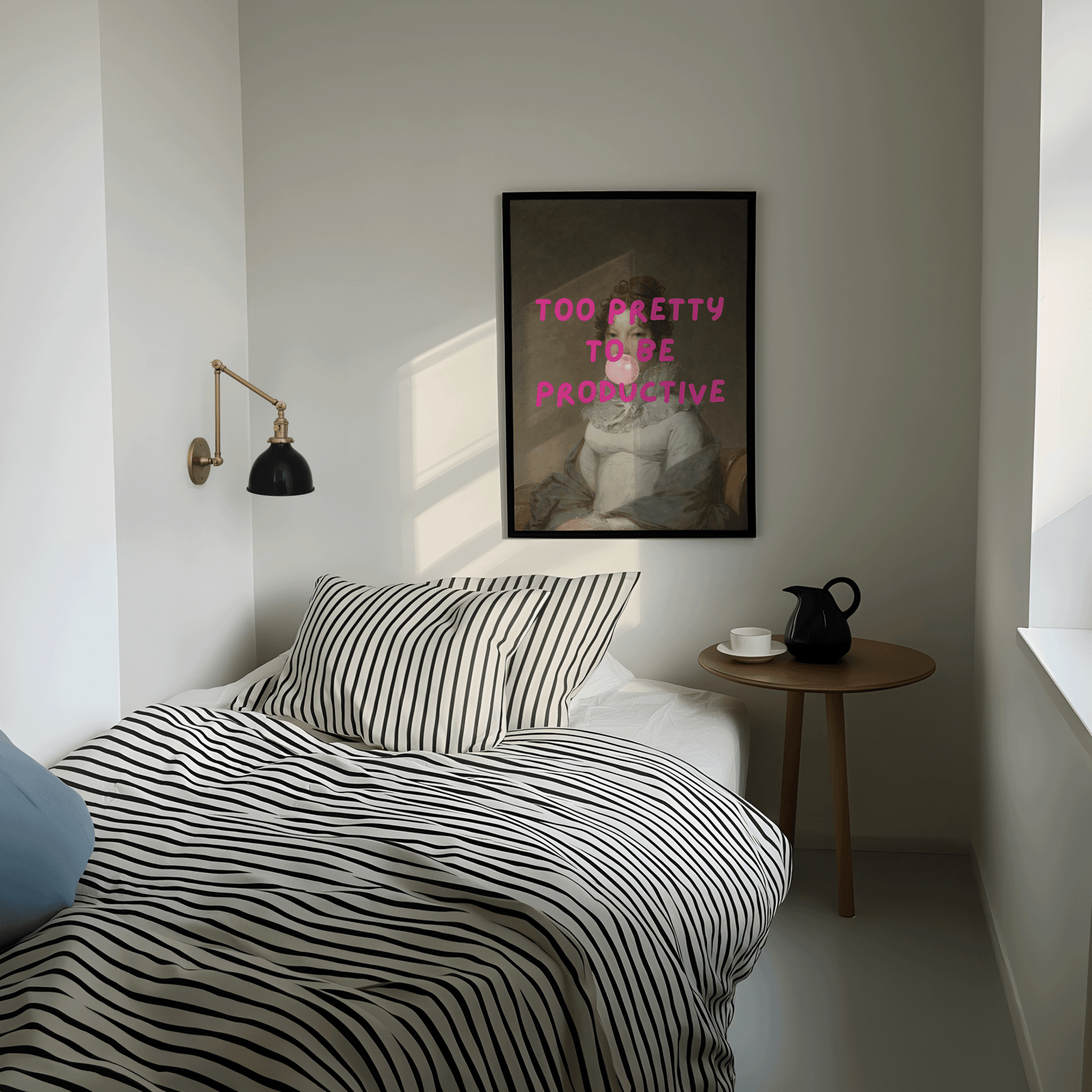 Modern bedroom with striped bedding, side table, and framed modern funny wall art print with 'too pretty to be productive' text.