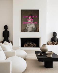 Modern living room with a fireplace, white sofa, and modern funny woman with bubble gum and pink text framed wall art.