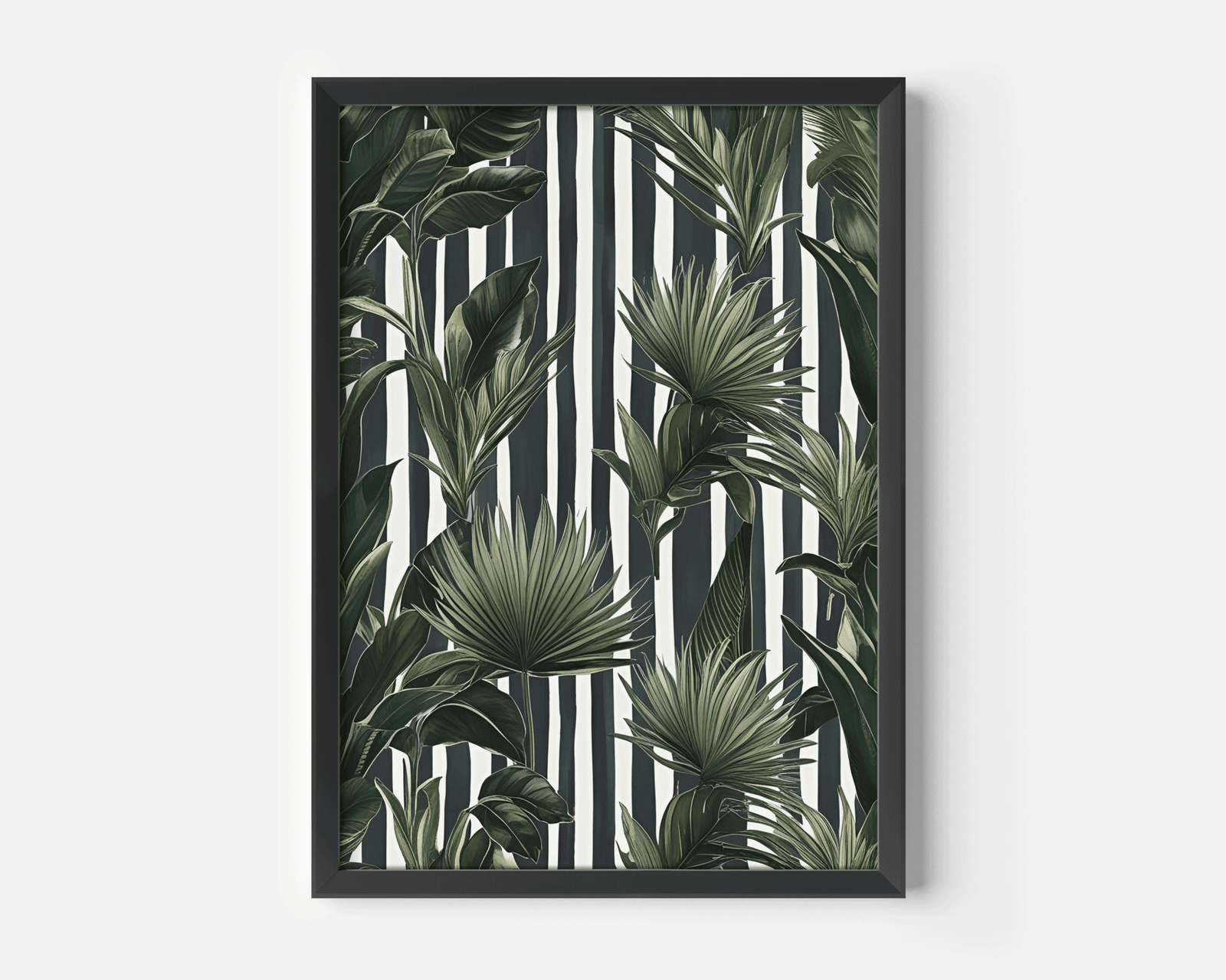 Tropical leaves wall art in a black frame, green botanical print on a black and white striped background