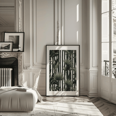 Tropical leaves wall art in a black frame leaning in a classic Parisian apartment
