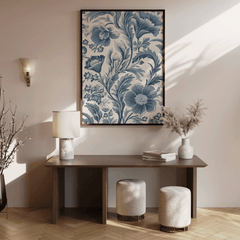 Vintage blue floral print above a dark wood console with a lamp