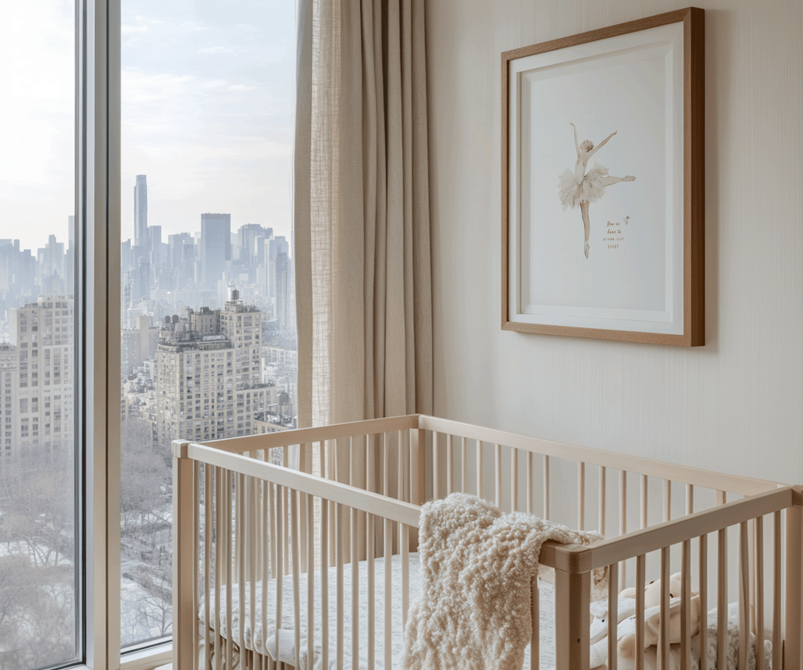 Framed vintage ballerina with tutu illustration on beige wall; warm cream nursery styling with a plush blanket in the crib overlooking the city.