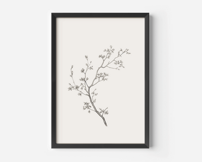 Black-framed wall art print of a black and white minimal branch sketch on a white background