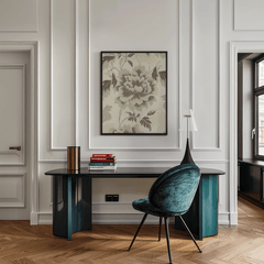Vintage botanical wall art with green floral pattern and beige background displayed above desk in stylish modern office