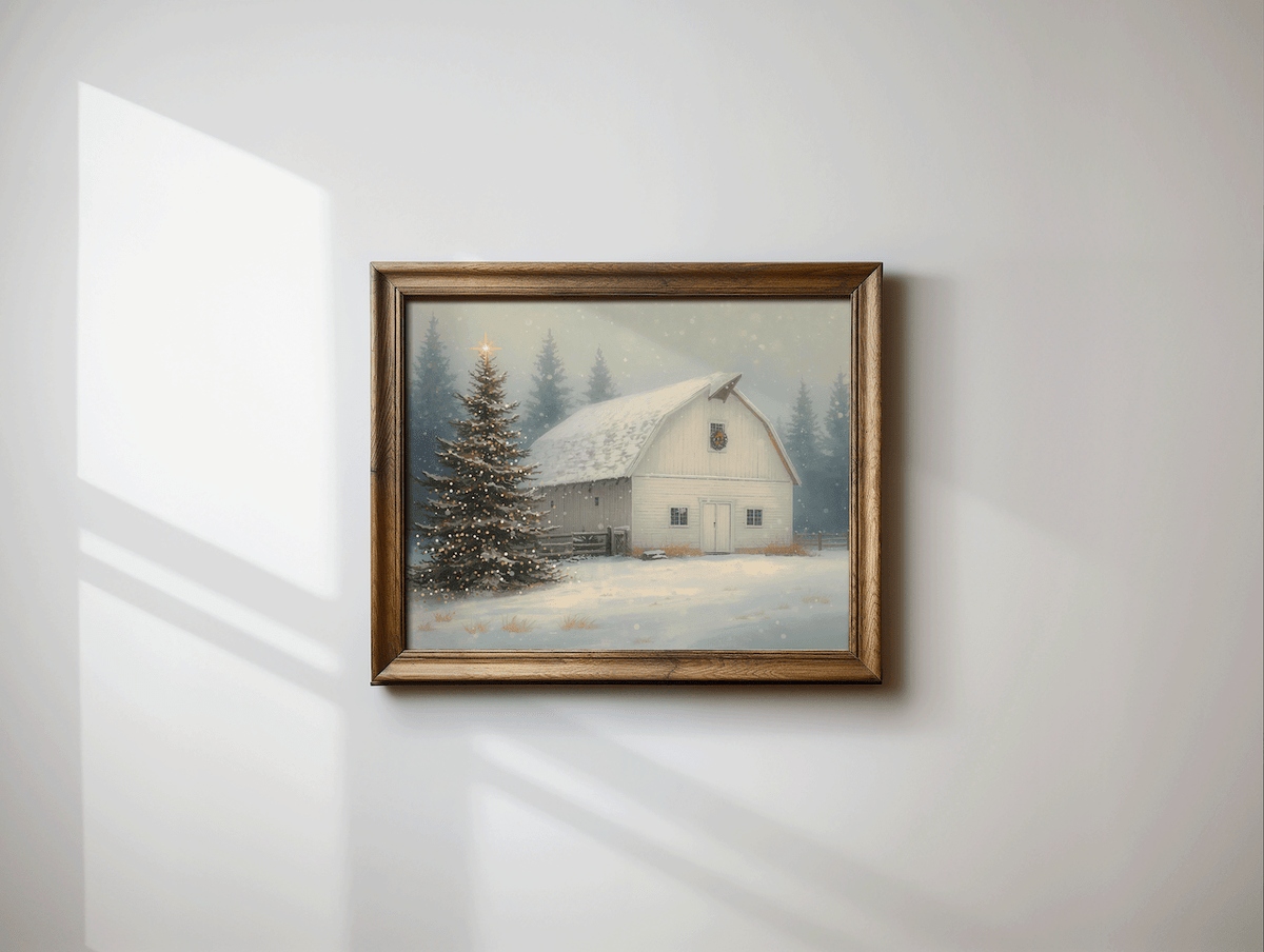 Vintage Christmas barn print in a rustic brown wood frame with a snowy white barn, glowing tree and soft snowfall