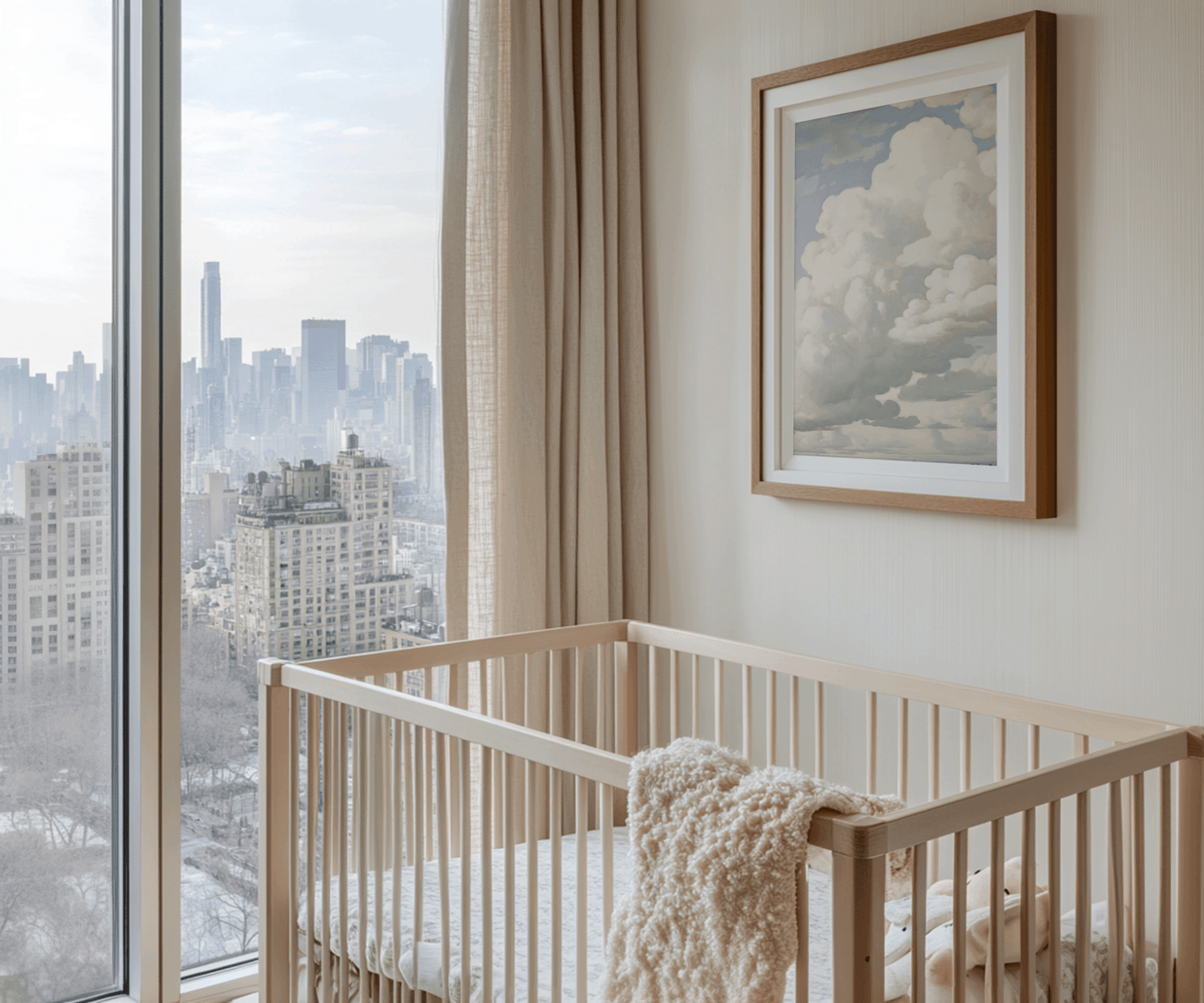 Nursery with wooden crib, framed vintage clouds and blue skies wall art print, and city view