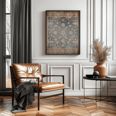 Black framed vintage tapestry wall art above a leather armchair