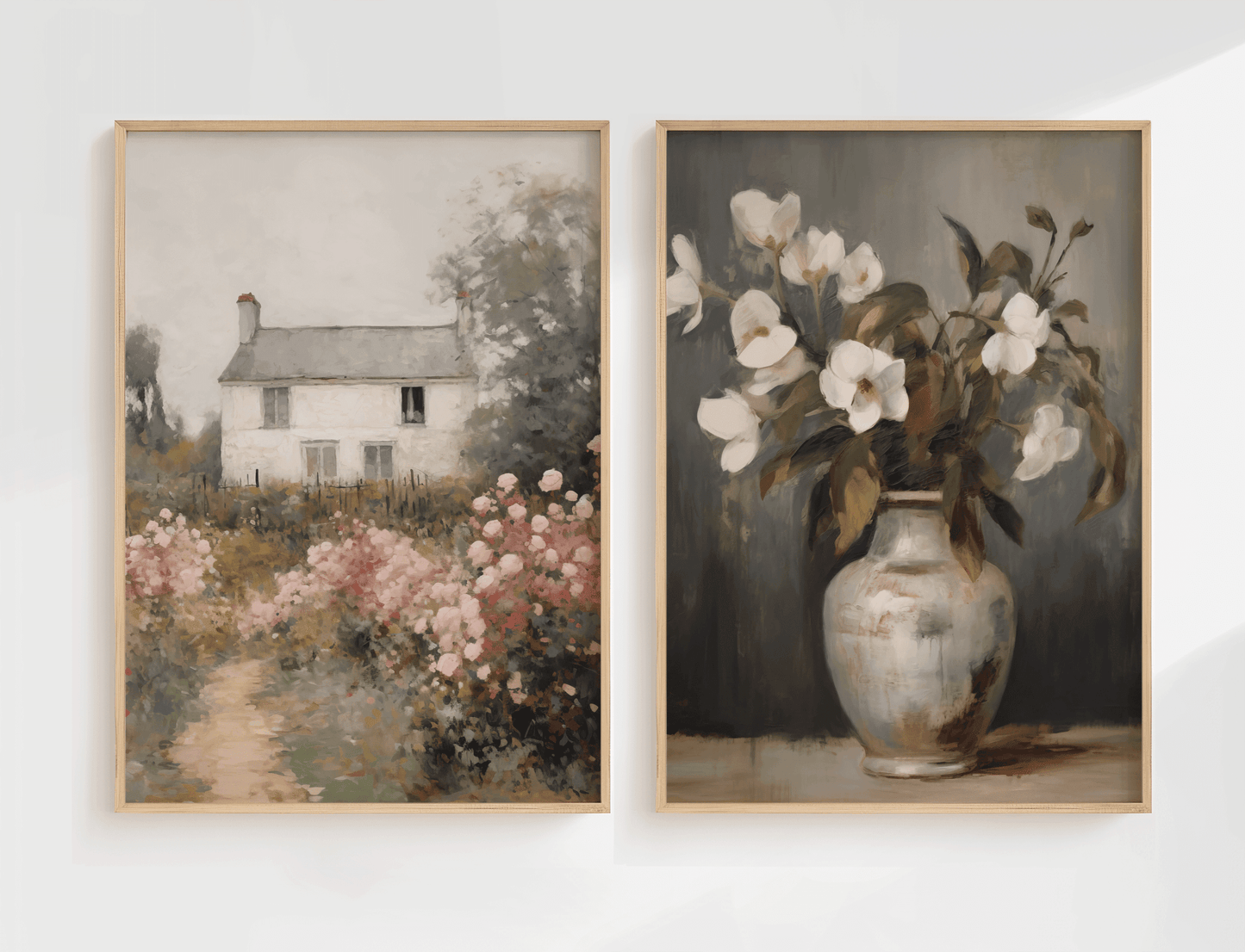 Set of 2 vintage wall art prints on white wall featuring cottage landscape and floral still life