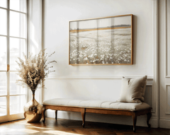 Vintage wildflower field print above a bench with a floral vase in an entryway