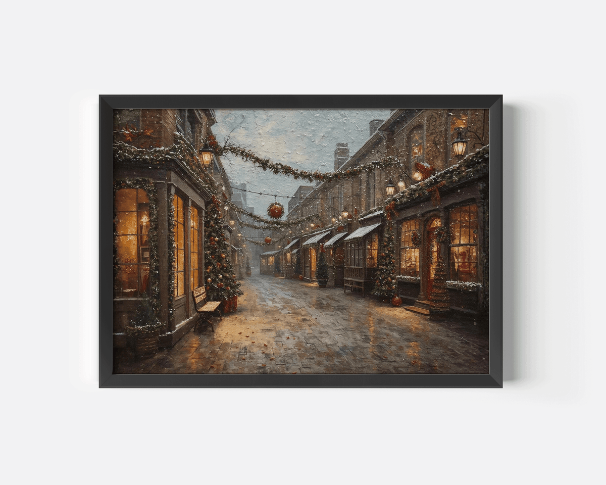 Vintage Christmas street scene print in a black frame with glowing windows, garlands and falling snow