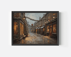 Vintage Christmas street scene print in a black frame with glowing windows, garlands and falling snow