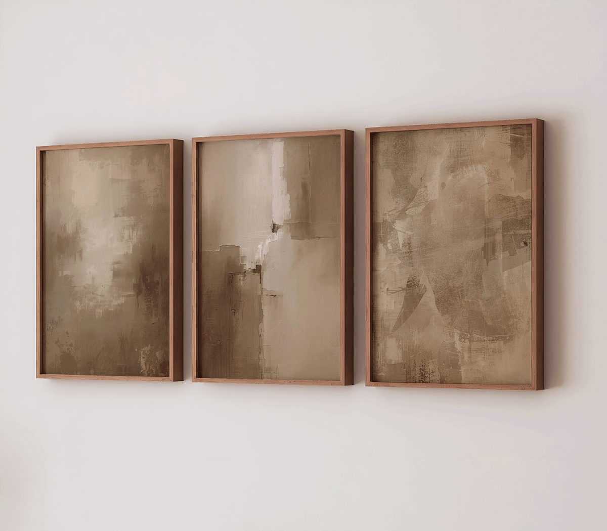 Set of three large warm beige and moody, earthy abstract canvas wall art prints in brown wood frames on a white wall