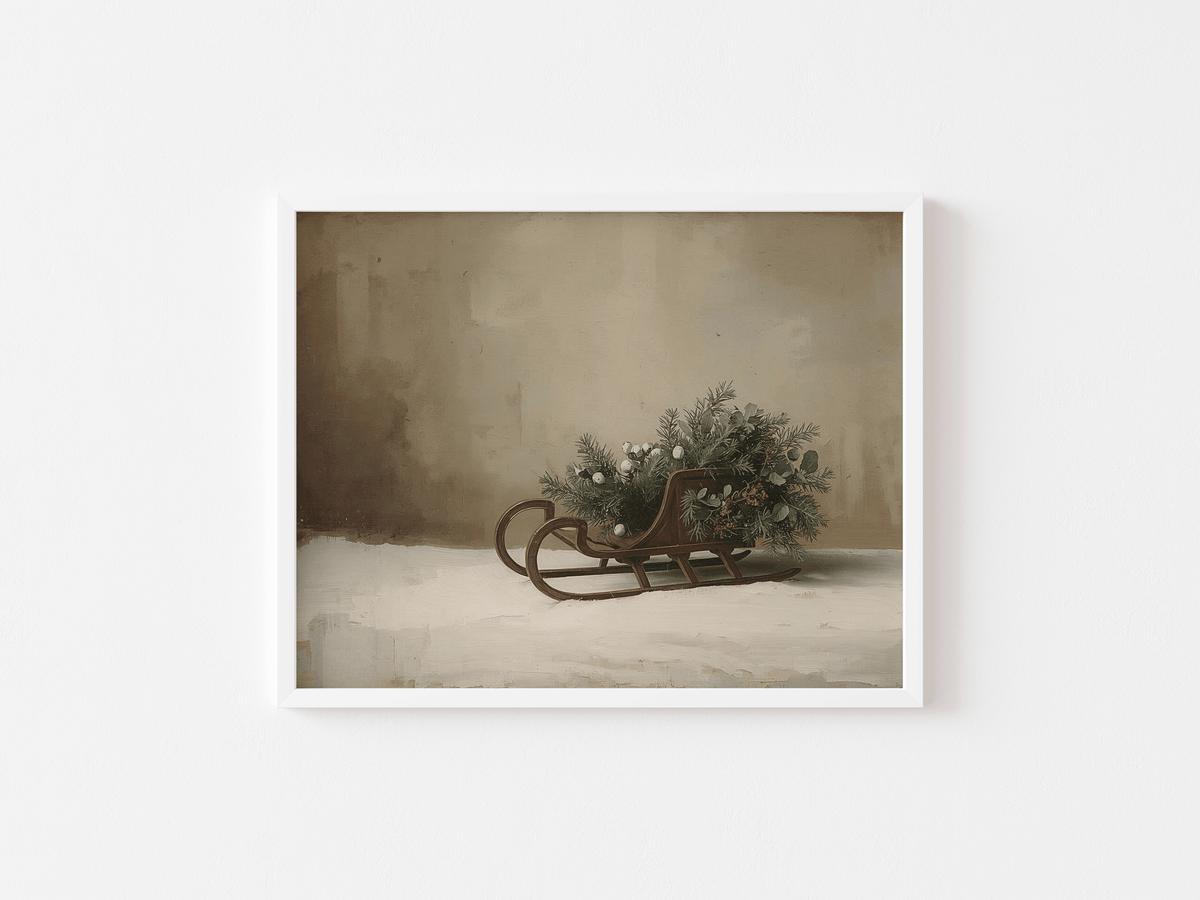 Vintage sleigh print in a white frame with winter greenery in soft neutral tones