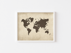 White-framed vintage world map wall art on a white wall