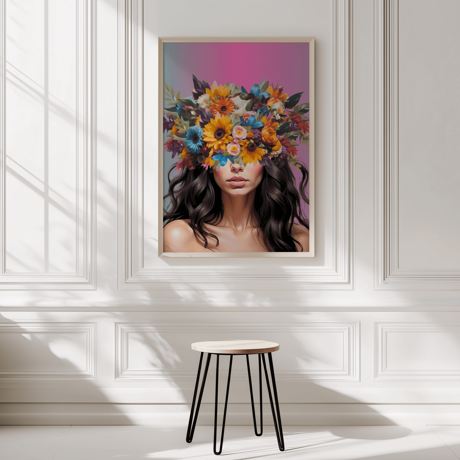 Woman with flower crown art print framed showcasing bright florals and feminine, bold charm on a white panelled wall with a beige stool in front.
