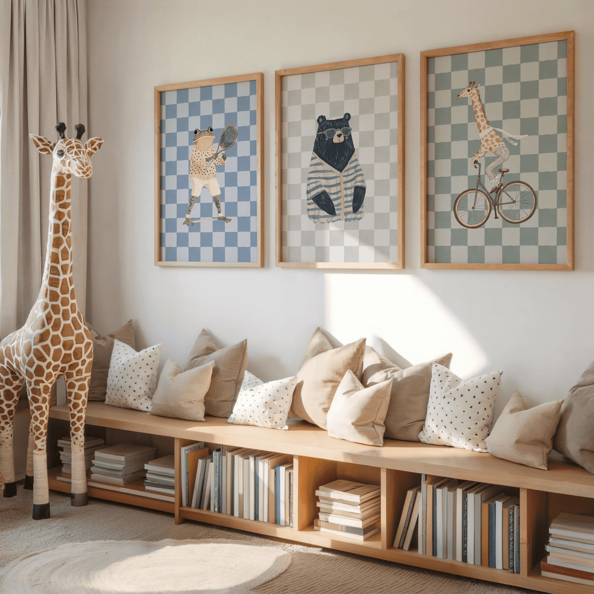 Set of three animal nursery prints with a giraffe, bear and frog above a wooden bench in a playroom