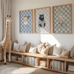 Set of three animal nursery prints with a giraffe, bear and frog above a wooden bench in a playroom