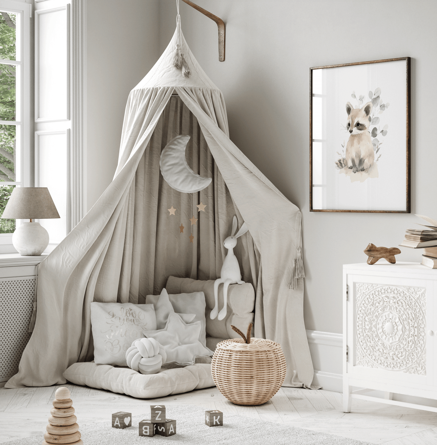 Woodland animal raccoon print in watercolor style, framed above soft canopy reading nook in a neutral nursery