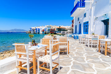 Chairs with tables in typical Greek tavern in Little Venice part of Mykonos town, Mykonos island, Greece