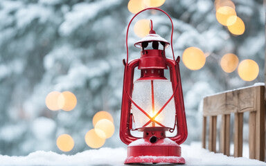 a red oil lamp on the snow, against the background of a blurred snow forest with a bokeh
